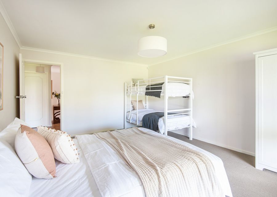 Downstairs bedroom with king bed and single bunk 