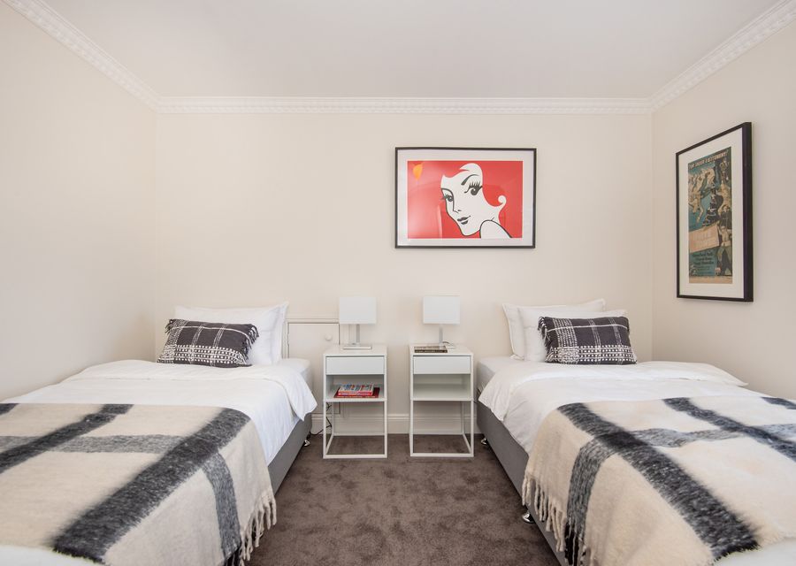 Bedroom four upstairs with two king single beds 