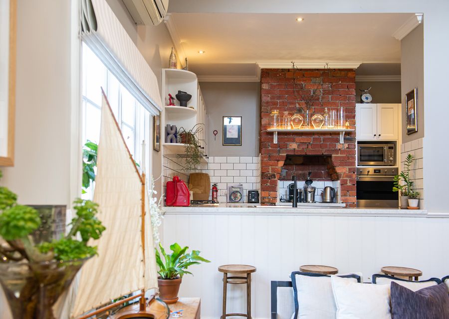 Elevated kitchen looking out onto the living space through to the gardens