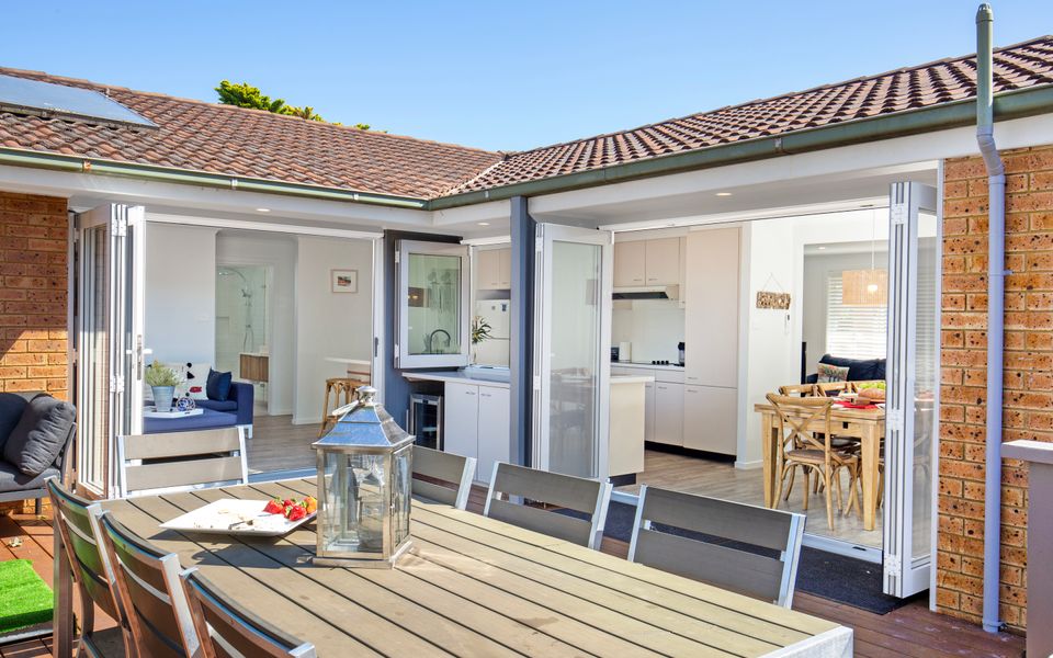 Latitude South Coast - accommodation jervis bay outdoor dining set looking into indoor lounge and kitchen