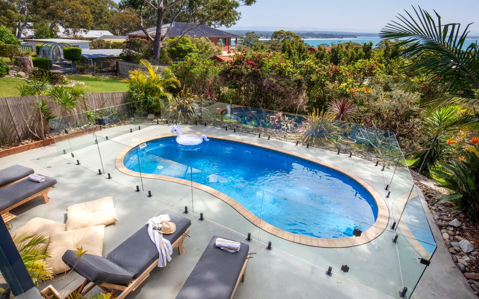 Latitude South Coast - vincentia holiday rentals pool with deck chairs