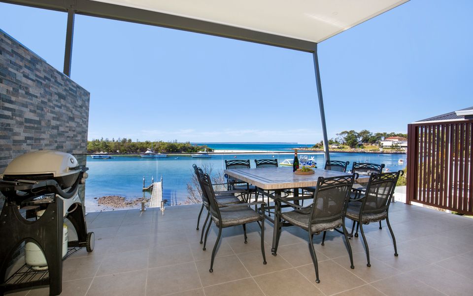 Latitude South Coast - jervis bay accommodation rear patio with dining set and barbeque overlooking the bay
