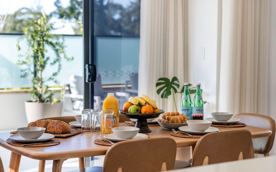 Latitude South Coast - huskisson accommodation dining room table with breakfast fruits and pasteries