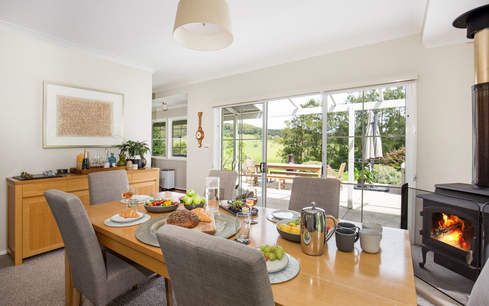 Latitude South Coast - pet friendly accommodation south coast dining room with indoor fireplace