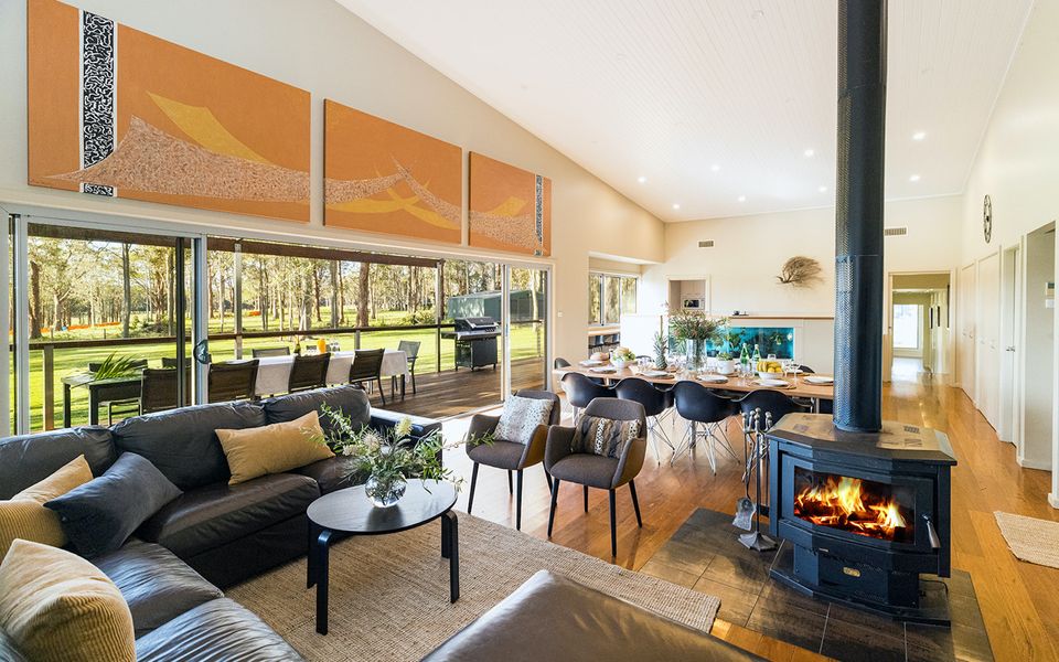 Latitude South Coast - pet friendly accommodation nsw indoor dining and living room with fire place