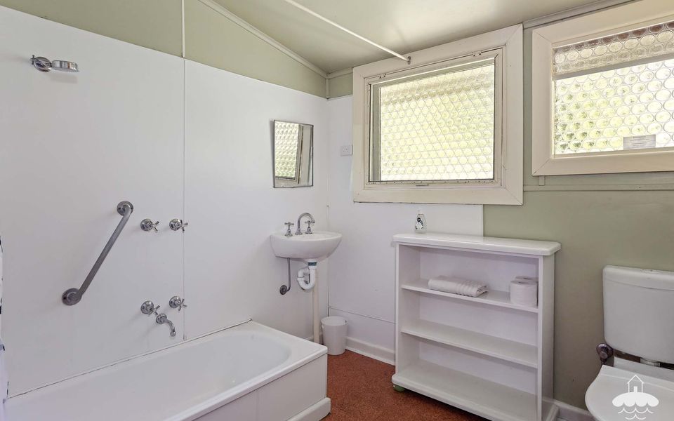 Main Bathroom with a shower over the bath