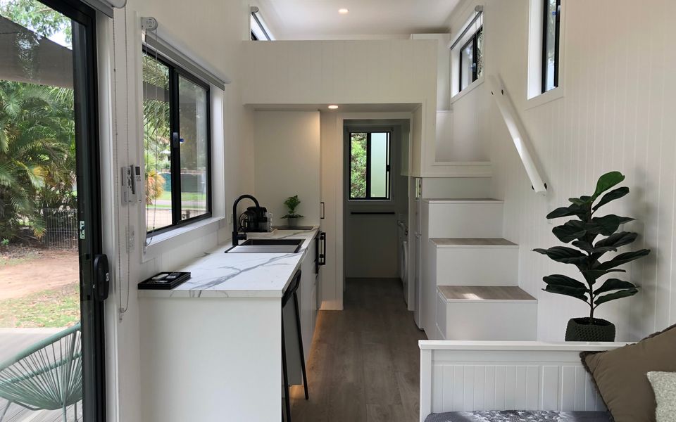 Open plan living area and steps to the bed