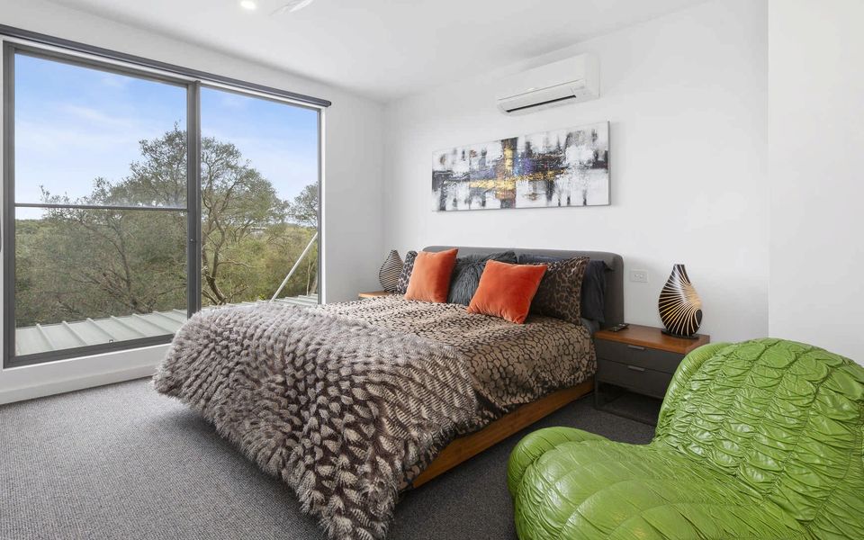 Master bedroom with a king-size bed located on the first floor, complete with an ensuite bathroom.