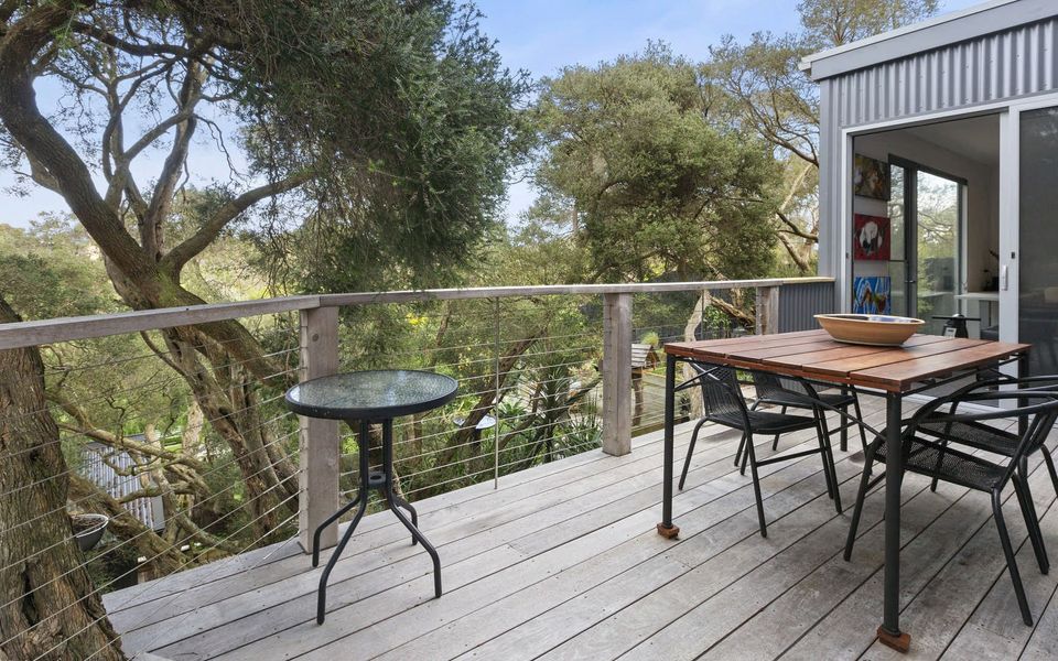 Outdoor deck with view over the landscaped back garden, accessed via bedroom 4 and the rumpus room