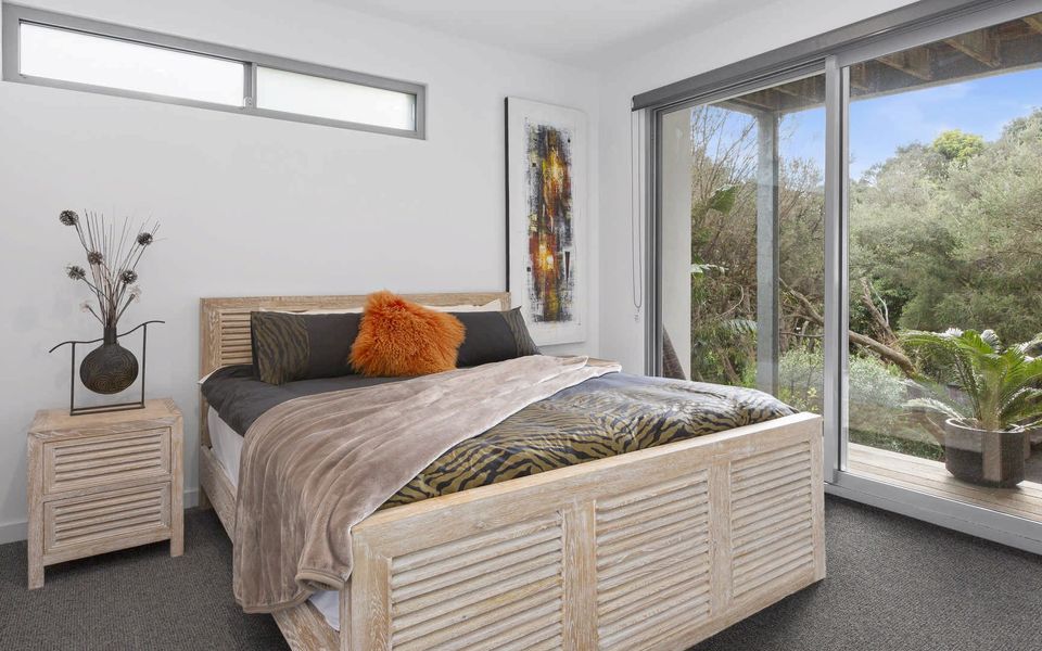 King Bedroom with ensuite and sliding door opening to the beautifully landscaped front garden