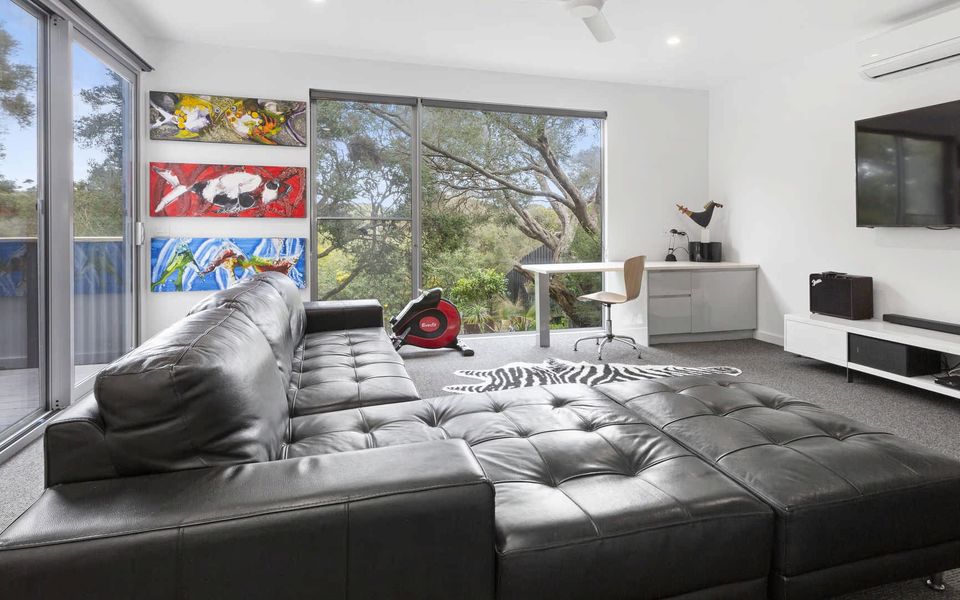 Rumpus room equipped with exercise bike, rowing machine., desk, mini fridge, coffee machine and sofa bed (on request) With access on to outdoor deck