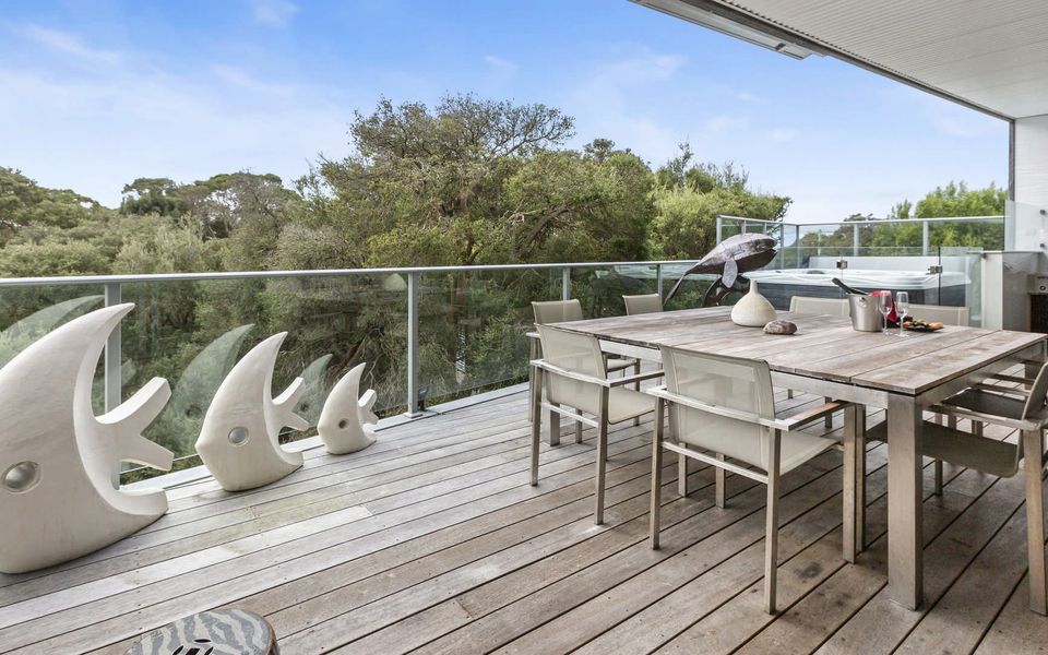 Outdoor entertaining area with heated spa, BBQ, TV, separate powder room and remote controlled outdoor awning.