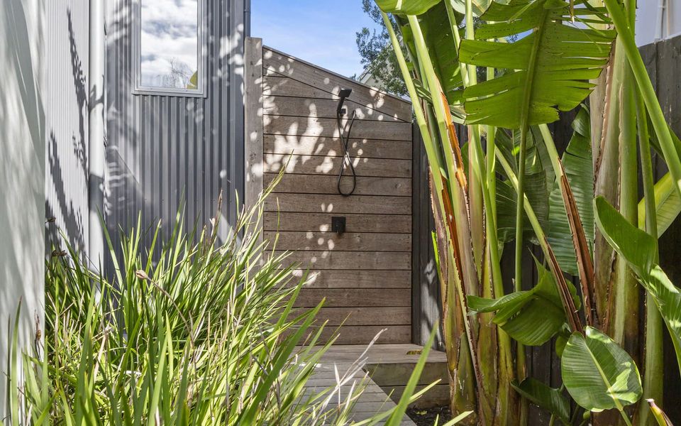 Outdoor shower located to the right of the house.