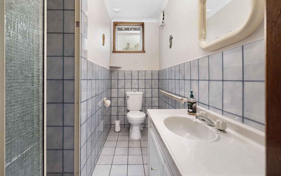 Ground floor bathroom with shower and adjoining laundry