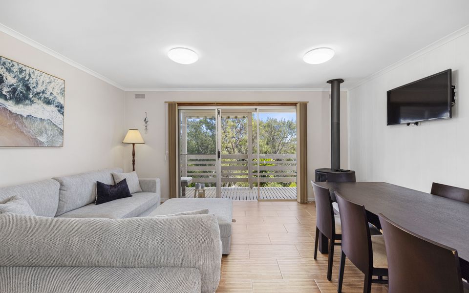 Open plan living dining area, with access on to balcony.