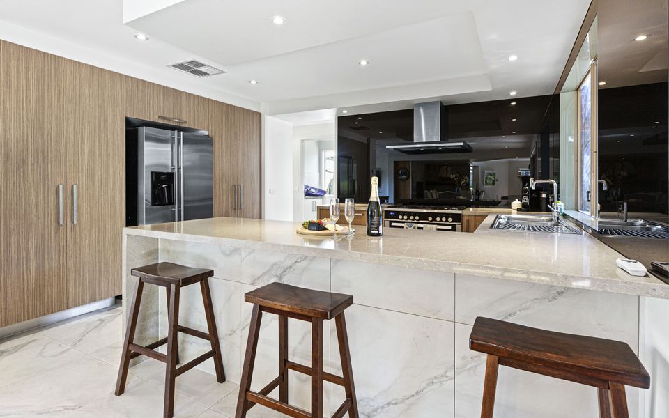Large well equipped kitchen with breakfast bar and three stools
