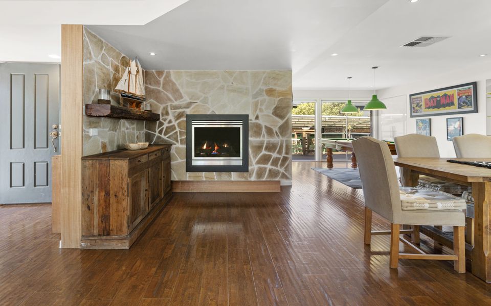 Open plan living dining area with fire.