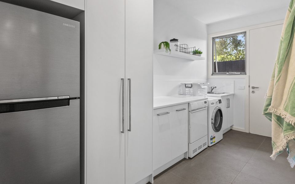 Laundry with washing machine, dryer and second fridge/freezer