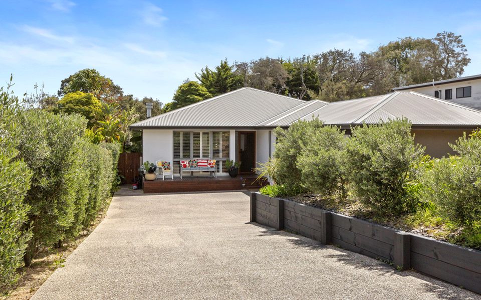 Long driveway with secure gate and landscaped garden
