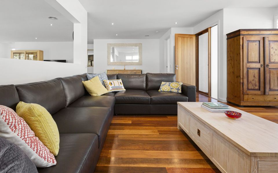 Second living area with gas log fire and comfy King Leather couches