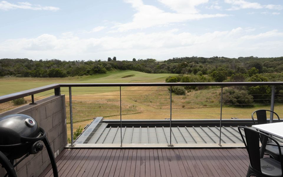 Large deck with BBQ and outdoor table and chairs.