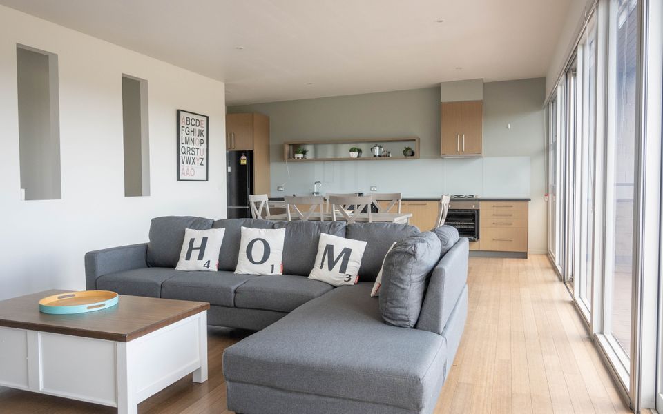 Open plan living dining/kitchen area with access to the outdoor deck.