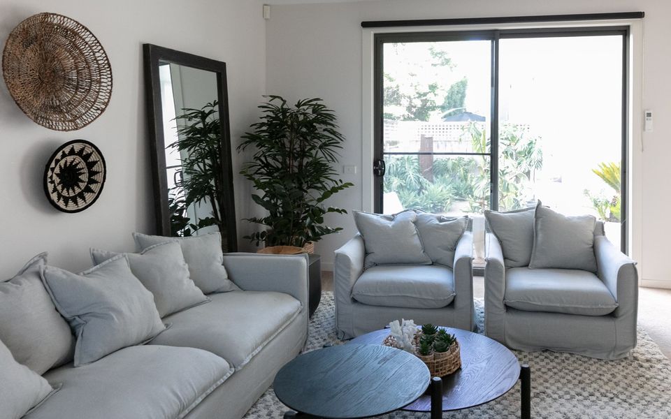 Living area with sofa bed and access to two outdoor courtyards.
