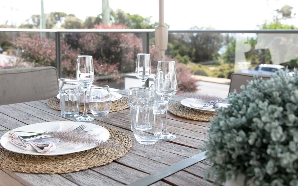 Balcony outdoor table for six people with bay views.