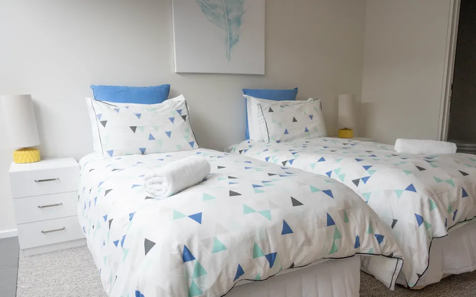 Bedroom with two King Singles or a King bed, built in robe and an ensuite.