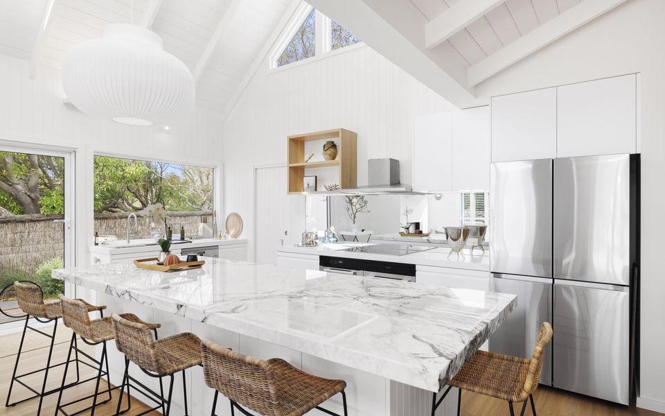Kitchen with marble island bench and five stools