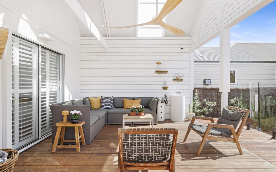 Relaxed outdoor seating area, with large ceiling fan, handbasin and access to the private pool