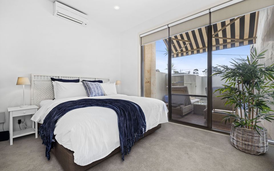 Bedroom 2 with King bed and views of the spa and pool