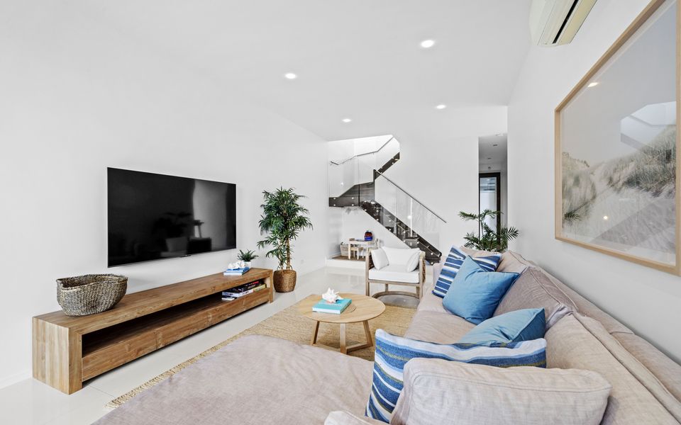 Living room with coastal touches, smart TV, large comfy couch and access to the heated pool and spa