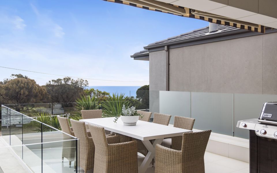 Terrace with retractable awning and outdoor dining for eight