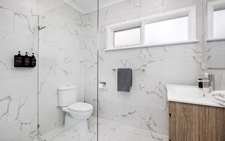 Family bathroom with shower, toilet and vanity unit.