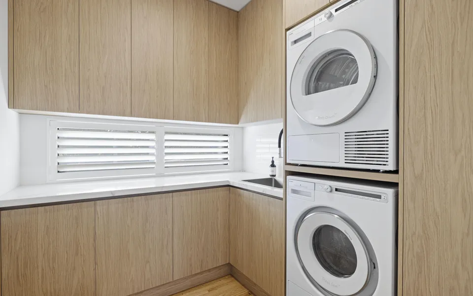 Laundry with washing machine, dryer and plenty of storage.
