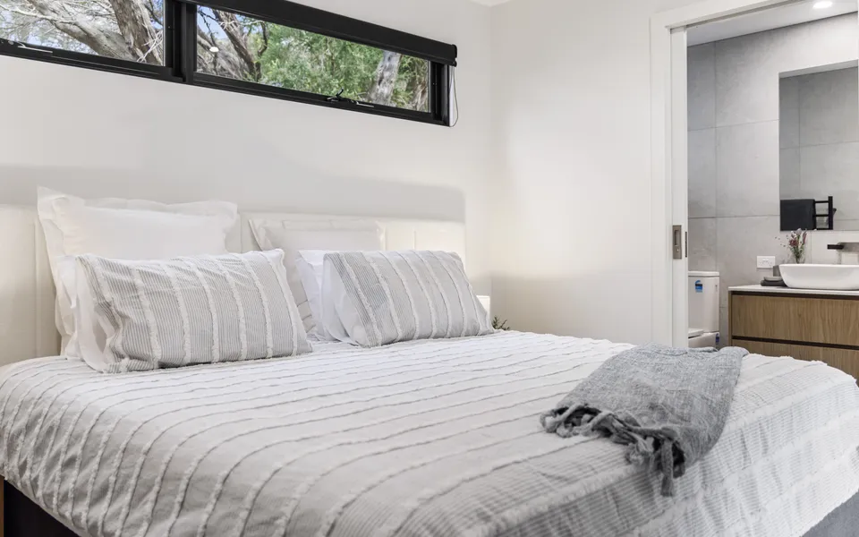 Lower-ground bedroom with flexible bedding setup (king or king singles) and its own ensuite.