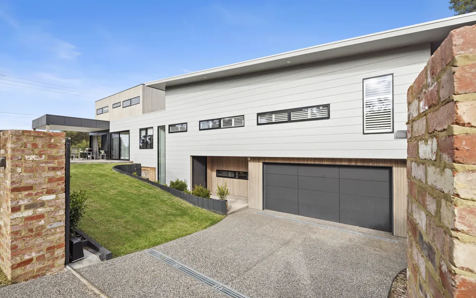 The peaceful front garden and coastal facade of Coastmere, a luxury holiday home in Rye, Mornington Peninsula