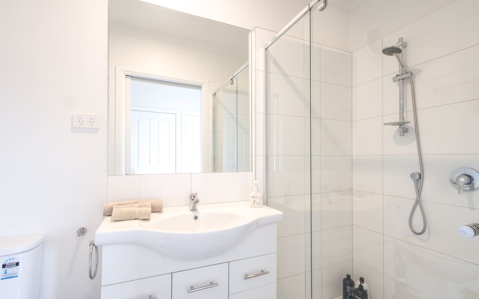 Ensuite with Shower, toilet and vanity, towels are provided.
