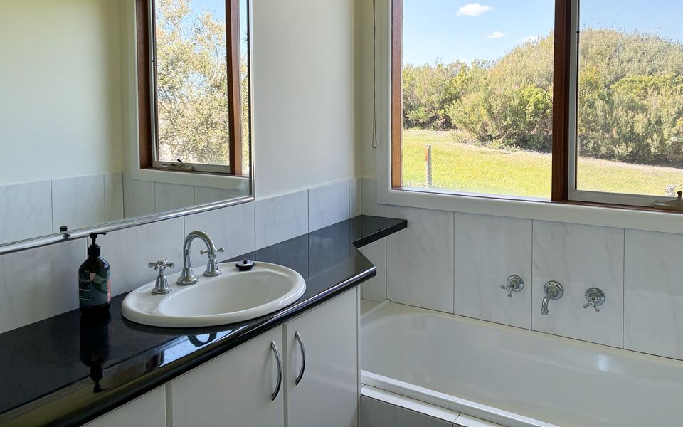 Family bathroom complete with bath, separate shower and vanity. There is a powder room adjacent to the bathroom.