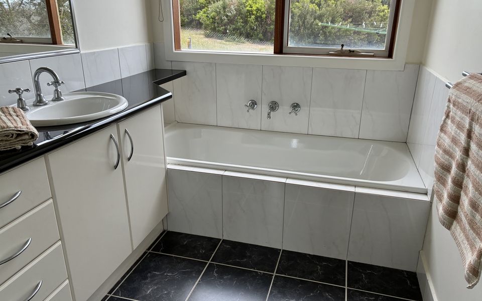 Family bathroom complete with bath, separate shower and vanity. There is a powder room adjacent to the bathroom.