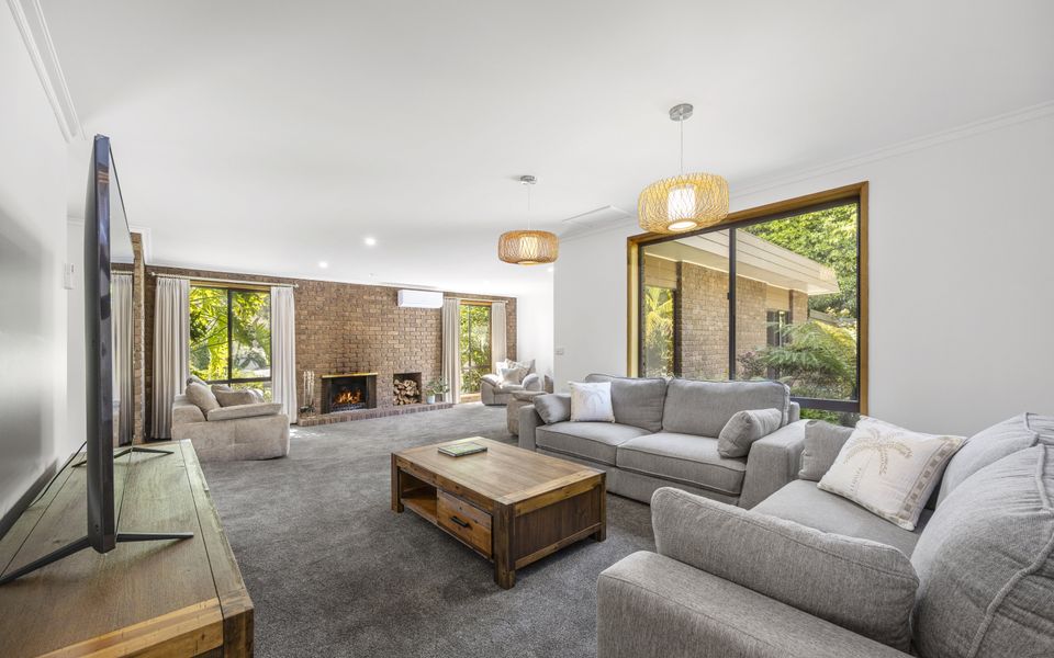 Large family lounge with Smart TV and plenty of comfy couches for relaxing.