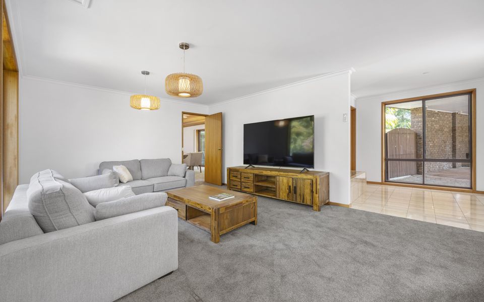 Large family lounge with access to the kitchen and dining area.