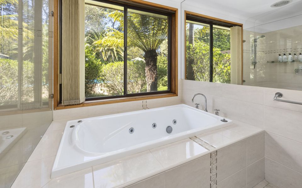 Large family bathroom, featuring a spa bath, separate shower, toilet and vanity.