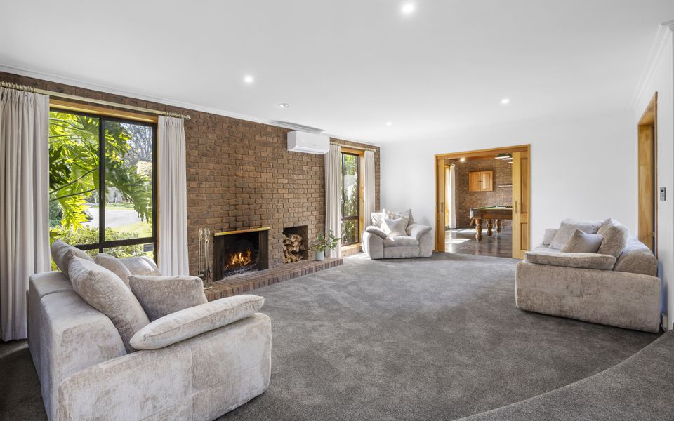 Second living area with open fire, split system, and sliding doors into the billiard room.