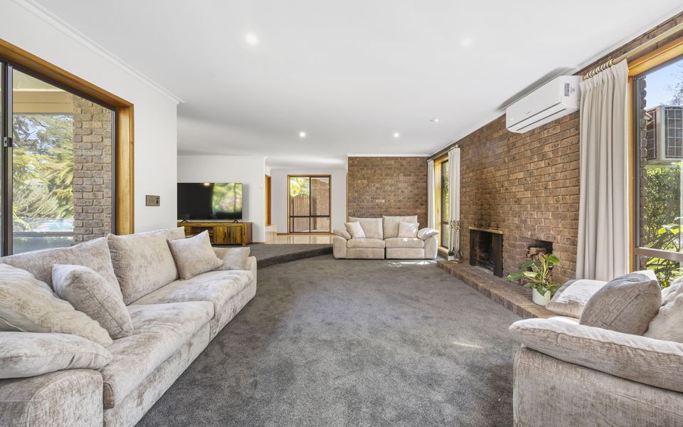 Second living area, a flexible space with open fire and split system, perfect for relaxing or gathering as part of the main lounge