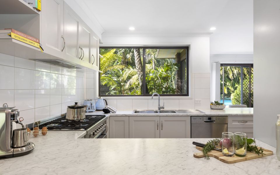 Spacious kitchen with modern appliances and a lovely poolside outlook