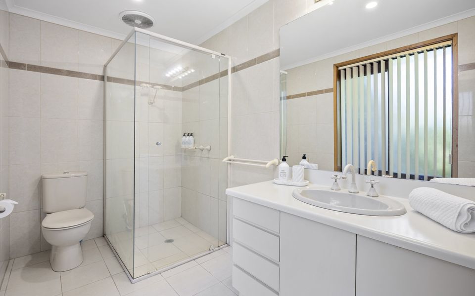 Ensuite to master bedroom with shower, toilet, and vanity.