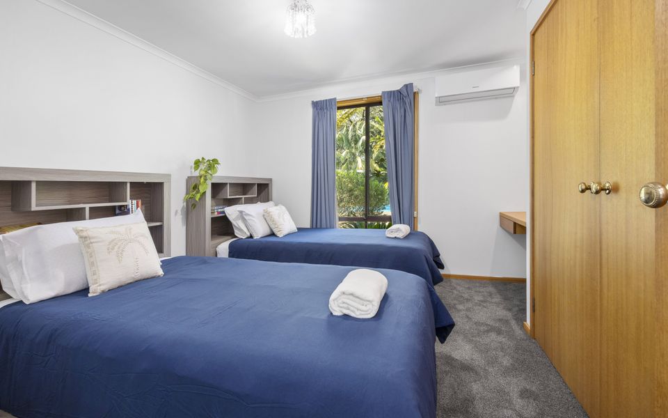 Bedroom 4 complete with two single beds , a wardrobe, and air conditioning/heating.