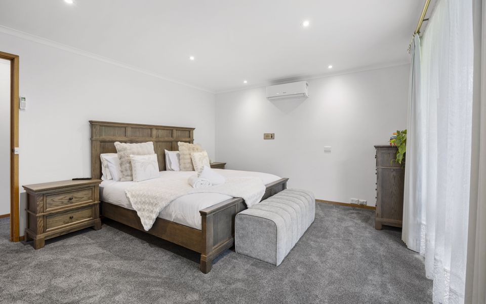 Master bedroom featuring King bed, private ensuite, walk-in wardrobe, and air conditioning/heating.